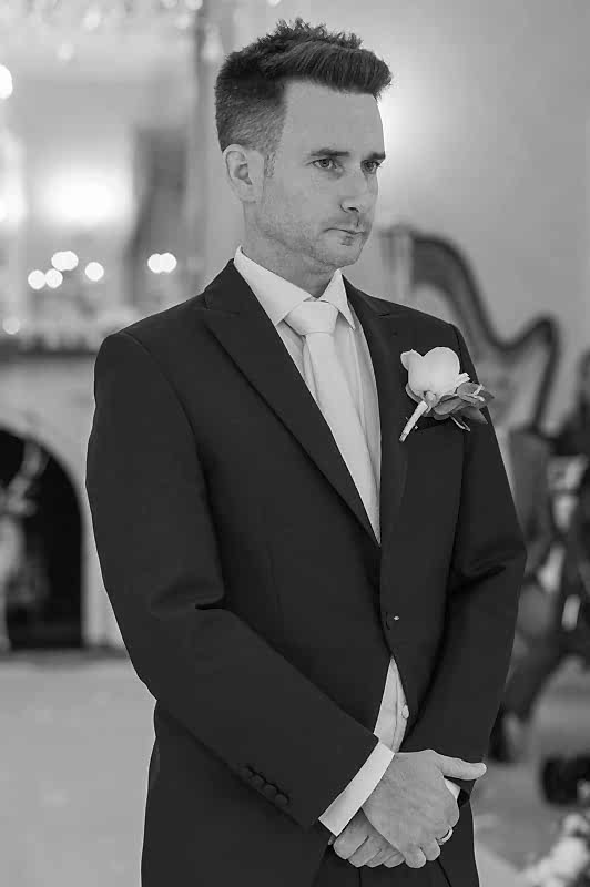 Groom at lakeside wedding venue