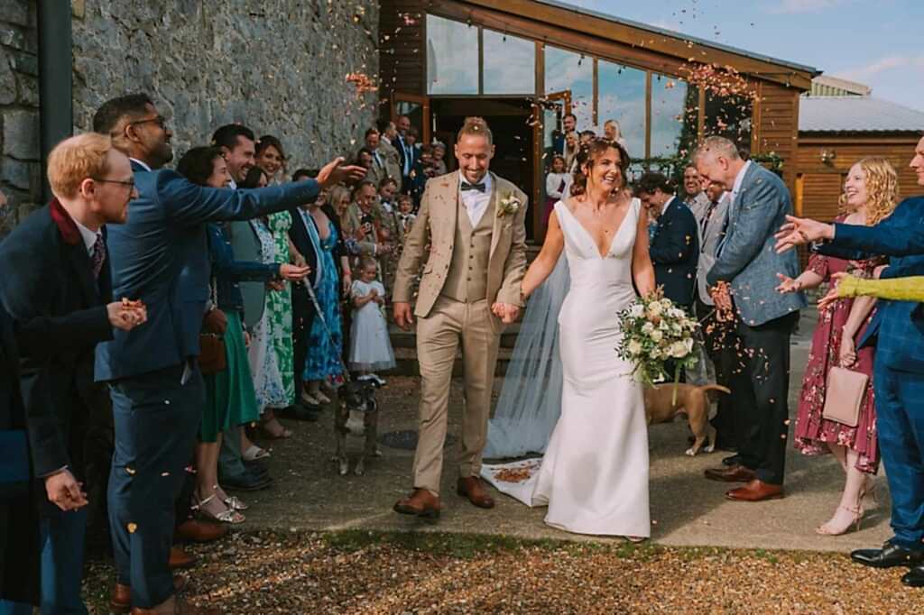 Bride and groom wedding confetti moment in South Wales countryside