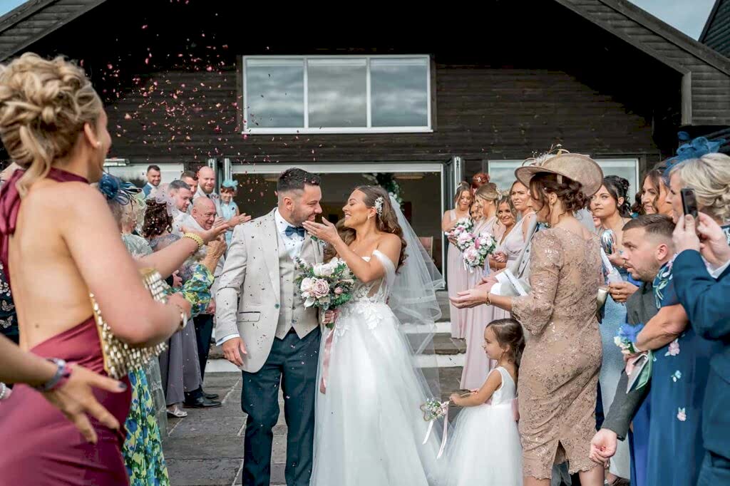 Bride and groom wedding confetti moment in South Wales countryside