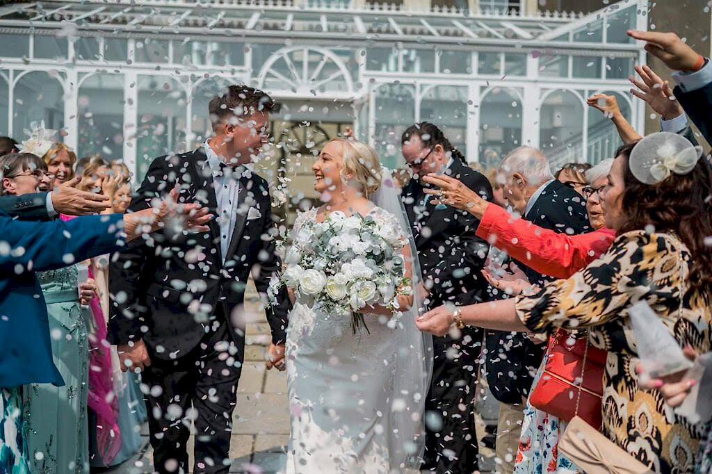 Bride and groom wedding confetti moment in South Wales countryside