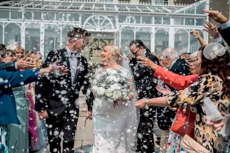 Bride and groom wedding confetti moment in South Wales countryside