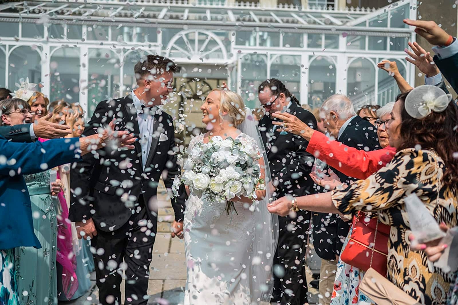 Bride and groom wedding confetti moment in South Wales countryside